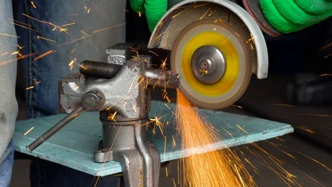 Worker with angular grinding machine is cutting the metal Stock Footage 78992405