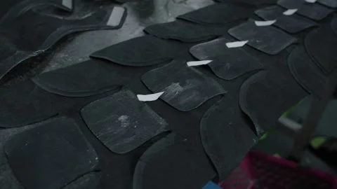 Worker Applies Adhesive Strips to Shoe Material Pieces in Factory Production Stock Footage 341666993