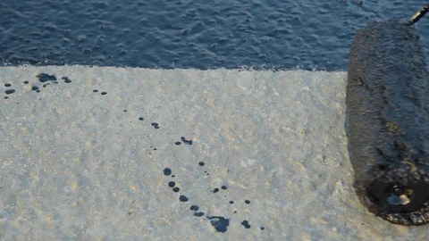 Worker applies bitumen mastic on the foundation Stock Footage 120417438