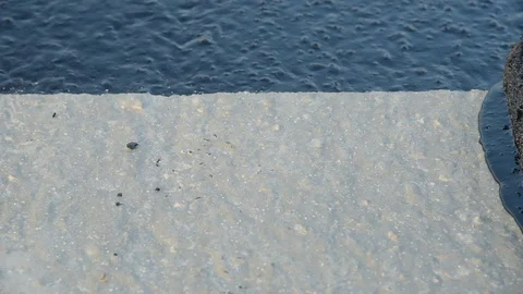 Worker applies bitumen mastic on the foundation Stock Footage 120423345
