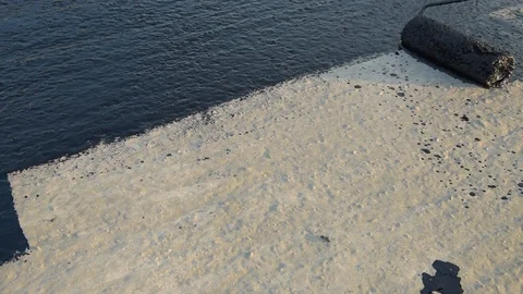 Worker applies bitumen mastic on the foundation Stock Footage 120423539