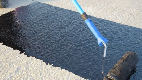 Worker applies bitumen mastic on the foundation Stock Footage 120480959