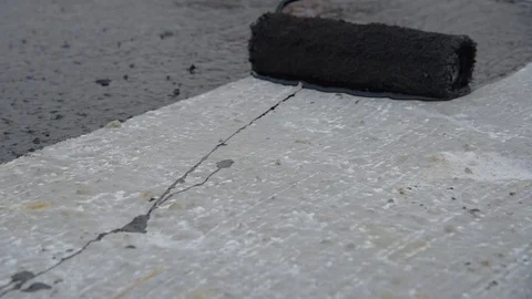 Worker applies bitumen mastic on the foundation Stock Footage 120481002
