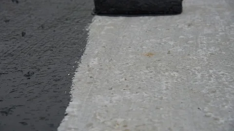 Worker applies bitumen mastic on the foundation Stock Footage 120511489
