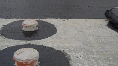 Worker applies bitumen mastic on the foundation Stock Footage 120567824
