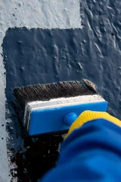 Worker applies bitumen mastic on the foundation Foto stock