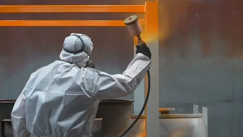 Worker applies bright orange paint to metal structure, spray gun, panoramic shot Stock Footage 120063005