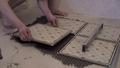 Worker applies glue for tiles Stock Footage 74060854