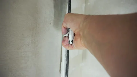 Worker applies putty on the wall Stock-Footage 146698883