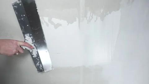 Worker applies putty on the wall Video stock 146910743