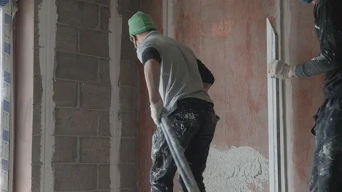 Worker apply plaster on the wall in pandemic Stock Footage 130048947