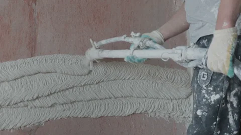 Worker apply plaster on the wall in pandemic Stock Footage 130049031