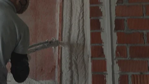 Worker apply plaster on the wall in pandemic Stock Footage 130049089