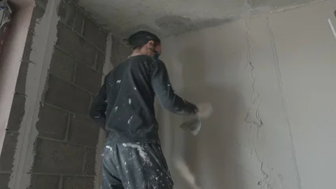 Worker apply plaster on the wall in pandemic Stock Footage 130049103