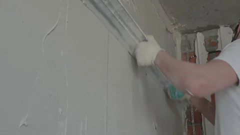 Worker apply plaster on the wall in pandemic Stock Footage 130049127