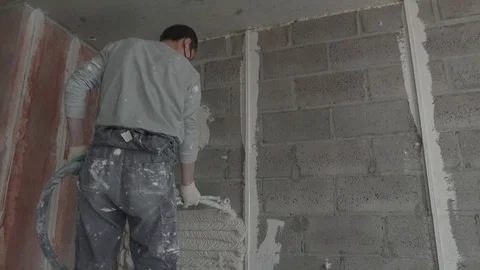 Worker apply plaster on the wall in pandemic Stock Footage 130049168
