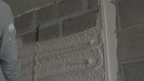 Worker apply plaster on the wall in pandemic Stock Footage 130049231