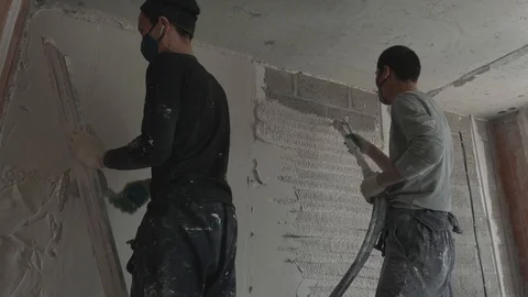 Worker apply plaster on the wall in pandemic Stock Footage 130049289