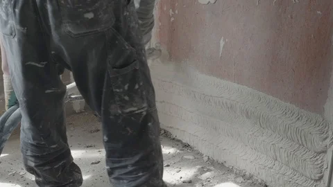 Worker apply plaster on the wall in pandemic Stock Footage 130049350