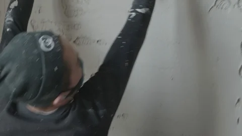Worker apply plaster on the wall in pandemic Stock Footage 130049406