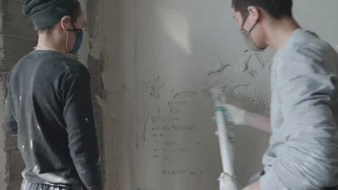 Worker apply plaster on the wall in pandemic Stock Footage 130049465