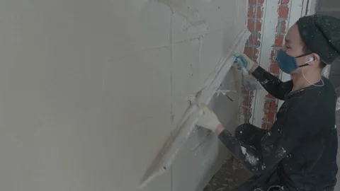 Worker apply plaster on the wall in pandemic Stock Footage 130049540
