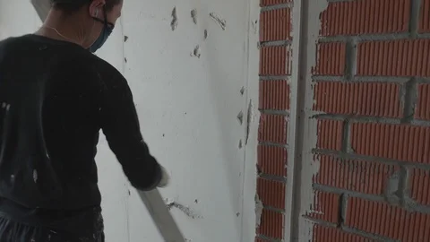 Worker apply plaster on the wall in pandemic Stock Footage 130049593