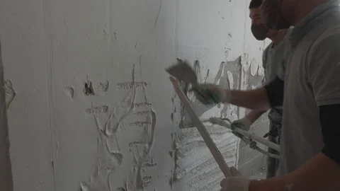 Worker apply plaster on the wall in pandemic Stock Footage 130049640