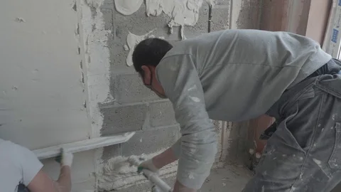 Worker apply plaster on the wall in pandemic Stock Footage 130049687