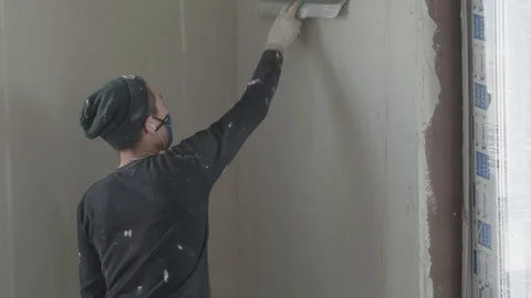 Worker apply plaster on the wall in pandemic Stock Footage 130049849
