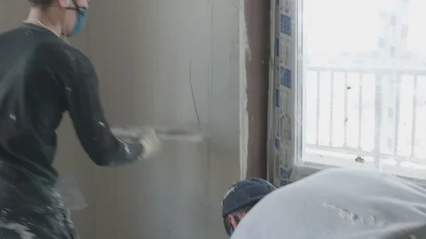Worker apply plaster on the wall in pandemic Stock Footage 130049891
