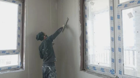 Worker apply plaster on the wall in pandemic Stock Footage 130049916