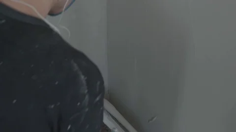 Worker apply plaster on the wall in pandemic Stock Footage 130049970