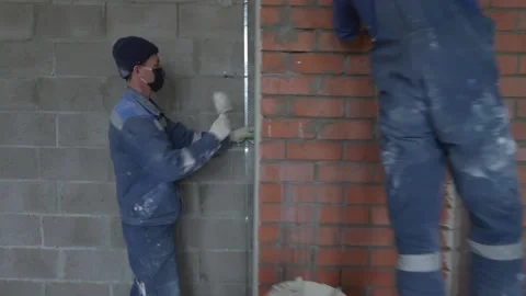 Worker apply plaster on the wall in pandemic 14.05.2020 Stock Footage 130425923