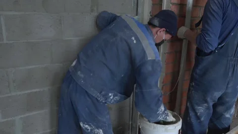 Worker apply plaster on the wall in pandemic 14.05.2020 Stock Footage 130425952