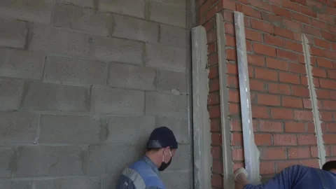 Worker apply plaster on the wall in pandemic 14.05.2020 Stock Footage 130425969
