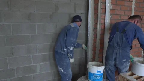 Worker apply plaster on the wall in pandemic 14.05.2020 Stock Footage 130425982