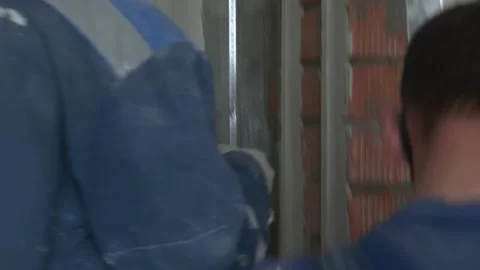 Worker apply plaster on the wall in pandemic 14.05.2020 Stock Footage 130425997