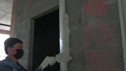 Worker apply plaster on the wall in pandemic 14.05.2020 Stock Footage 130426100