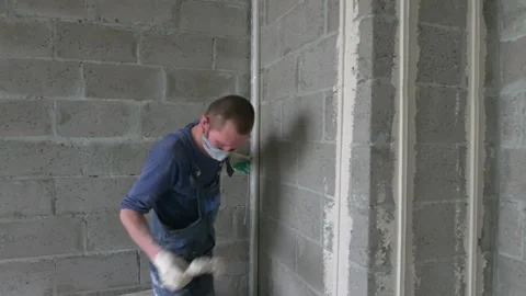 Worker apply plaster on the wall in pandemic 14.05.2020 Stock Footage 130426139