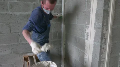 Worker apply plaster on the wall in pandemic 14.05.2020 Stock Footage 130426163