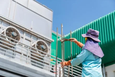 Worker apply a rust-proof primer to the rusty rebar. Stock Photos