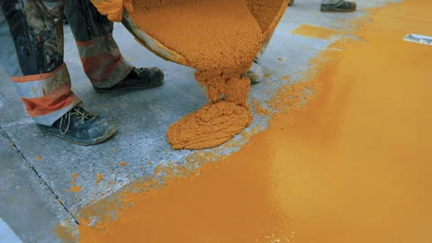 Worker applying epoxy and polyurethane flooring system.These easy-to-clean Stock Footage 162006679