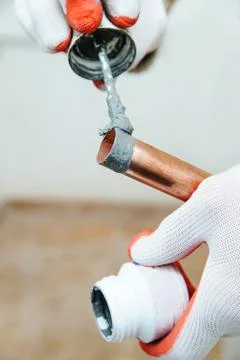 A worker is applying flux. Stock Photos