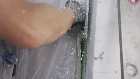 Worker Applying Foam Insulation to Exterior Wall During Construction, slow mo Video stock 297433091
