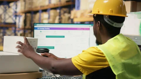 Worker applying labels and scanning tracking info numbers on barcodes tags Stock Footage 315705344