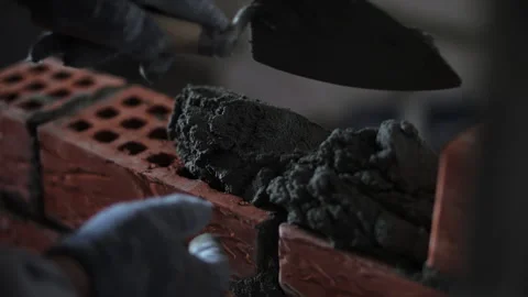 Worker Applying Mortar Between Clay Bricks Stock Footage 321858458