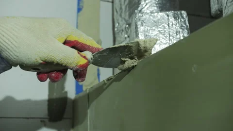 Worker Applying Plaster with Trowel on Wall Corner Stock Footage 303783846