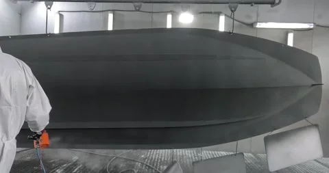 Worker Applying Powder Coating to RIB Boat Hull Видео 336097430