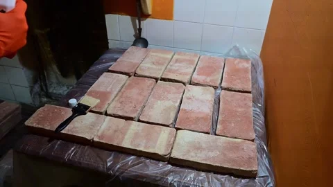 Worker applying a protective coating to terracotta bricks Video stock 346167937
